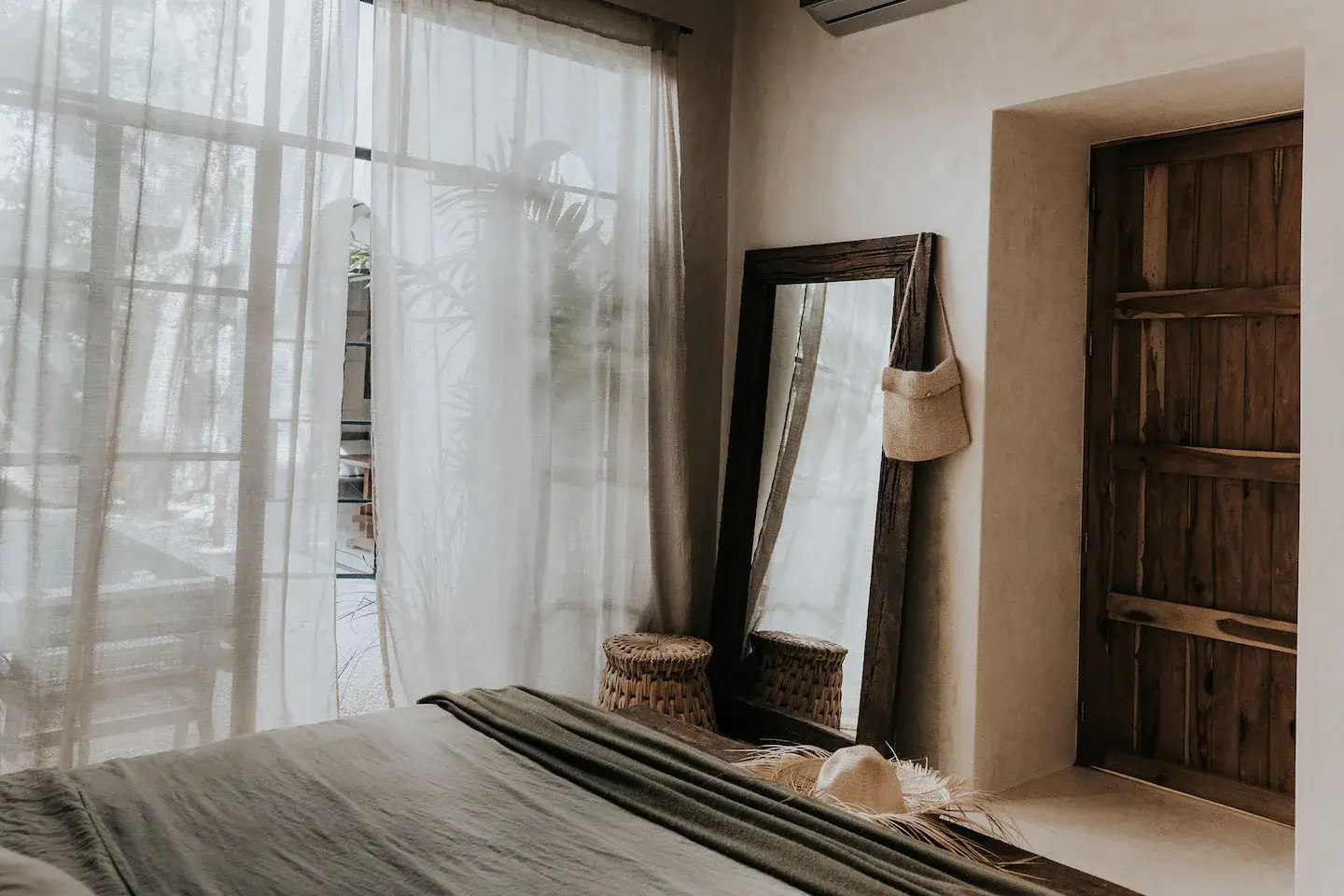 Rustic Wooden Elements in a Stylish Tulum Airbnb 20 natural-bedroom-large-wooden-mirror-rustic-wooden-door-nordroom
