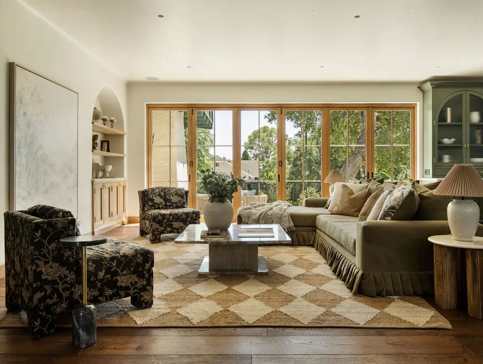 A Reimagined Spanish Colonial Revival Estate in Los Angeles 2 open-plan sitting room sage green color accents
