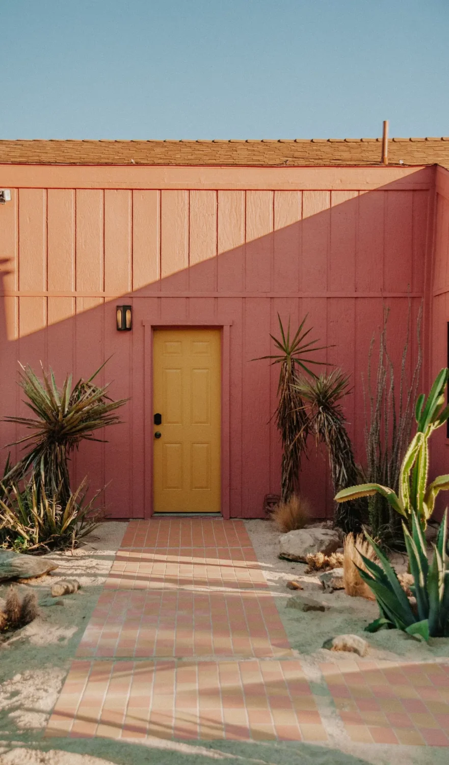 A Colorful Airbnb Home in the Morongo Valley 32 pink-exterior-airbnb-morongo-valley-yellow-front-door-nordroom