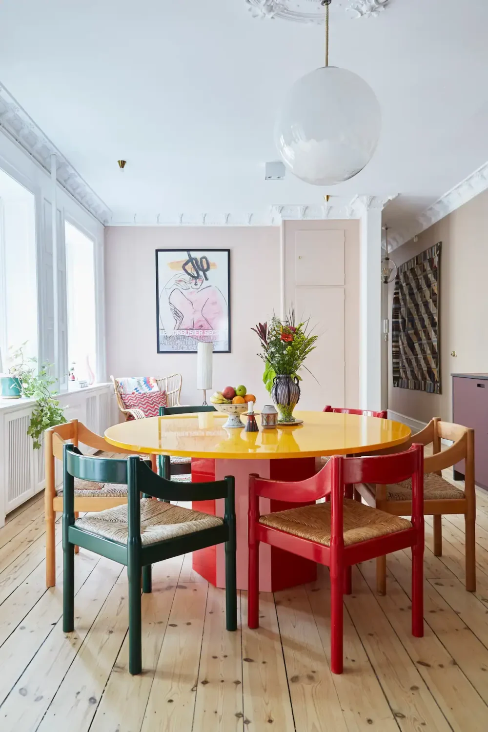 You Can Stay in This Colorful Design Apartment in Copenhagen 9 round dining tablewith colorful chairs
