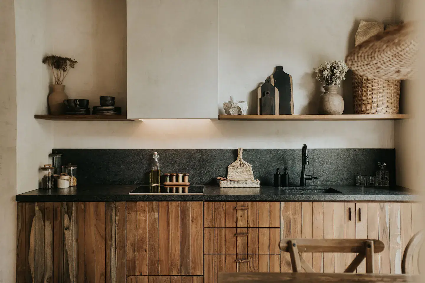Rustic Wooden Elements in a Stylish Tulum Airbnb 12 rustic-wooden-kitchen-cabinets-black-worktop-backsplash-open-wooden-shelf-nordroom