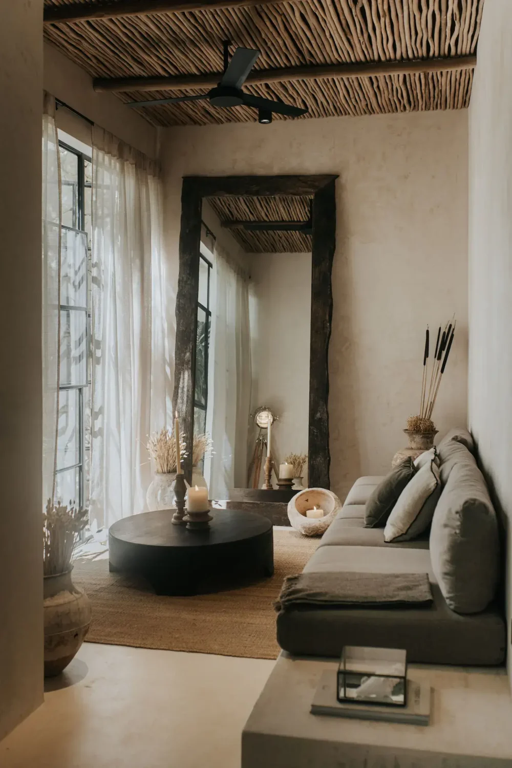 Rustic Wooden Elements in a Stylish Tulum Airbnb 6 small-natural-living-room-large-wooden-mirror-wooden-stick-ceiling-nordroom