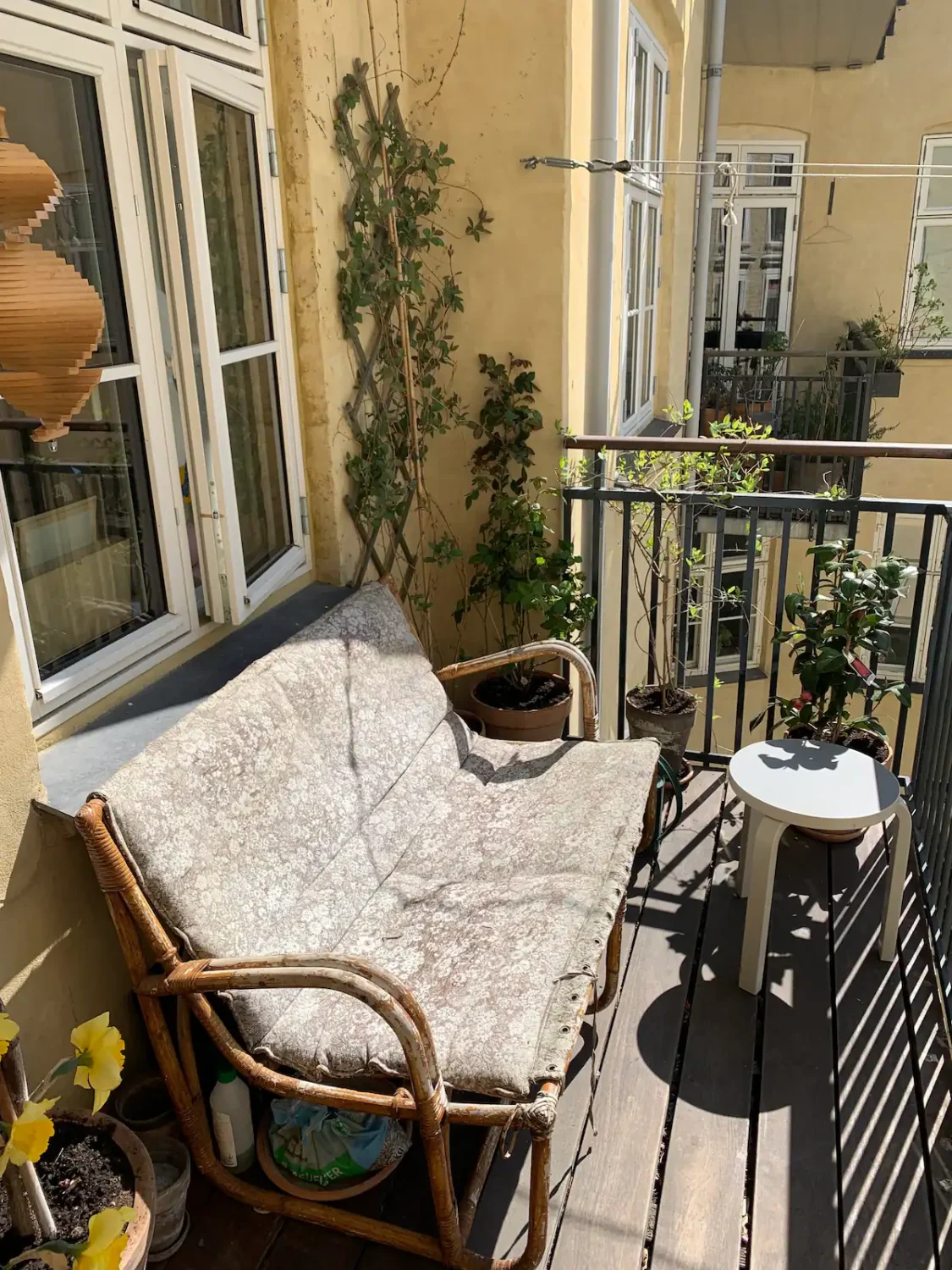 You Can Stay in This Colorful Design Apartment in Copenhagen 23 sunny balcony with rattan bench