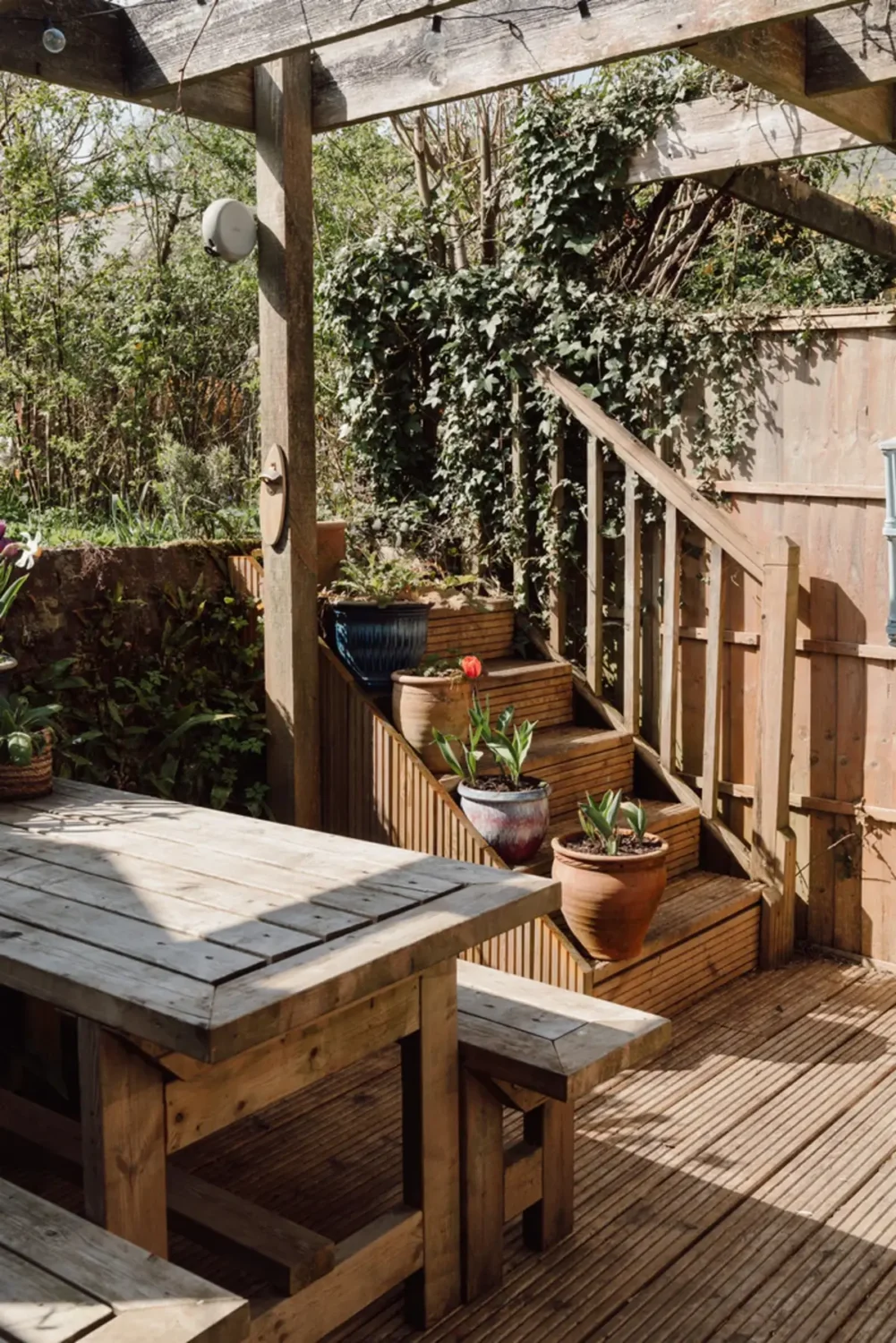 A Historic English Cottage Decorated in Pink & Blue Tones 11 wooden garden terrace pergola english cottage